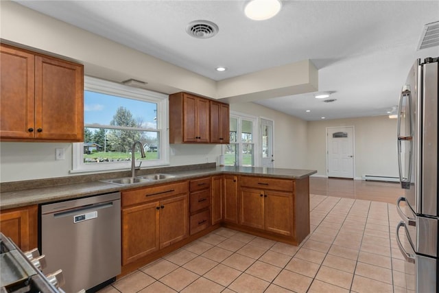33 Homestead Dr, Newton, IL 62448 - kitchen with appliances with stainless steel finishes, a sink, brown cabinetry, light tile patterned flooring, and recessed lighting