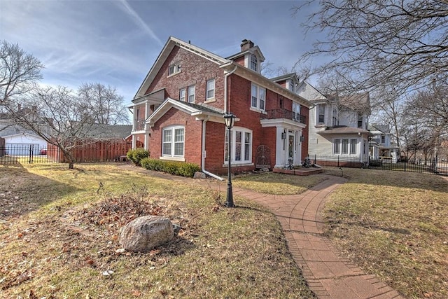 view of property exterior with fence private yard, brick siding, and a lawn