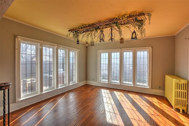 interior space featuring radiator, baseboards, ornamental molding, and dark wood-type flooring