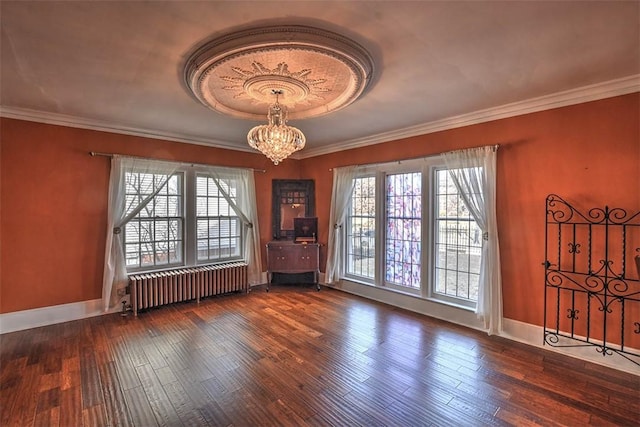 interior space featuring radiator, an inviting chandelier, dark wood finished floors, and a wealth of natural light