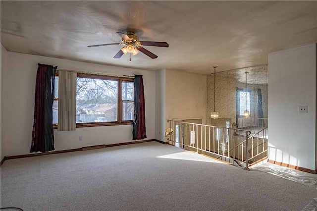 unfurnished room featuring carpet floors, a wealth of natural light, and ceiling fan