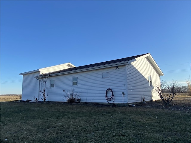 view of side of home featuring a yard