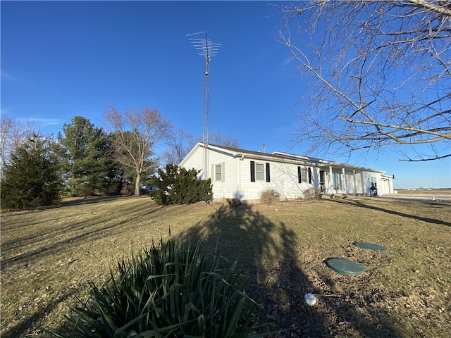 view of home's exterior with a lawn