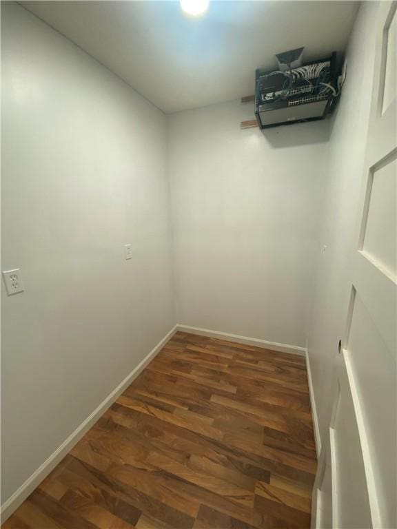 interior space with baseboards and wood finished floors