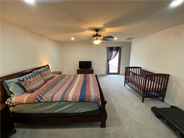 carpeted bedroom with a textured ceiling, baseboards, visible vents, and recessed lighting