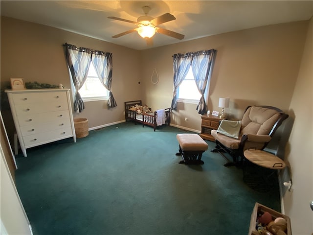 living area with carpet floors, plenty of natural light, baseboards, and a ceiling fan