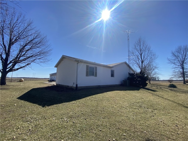 view of side of home featuring a yard