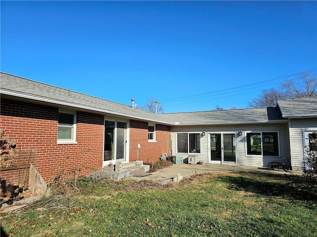 rear view of house featuring a yard and a patio