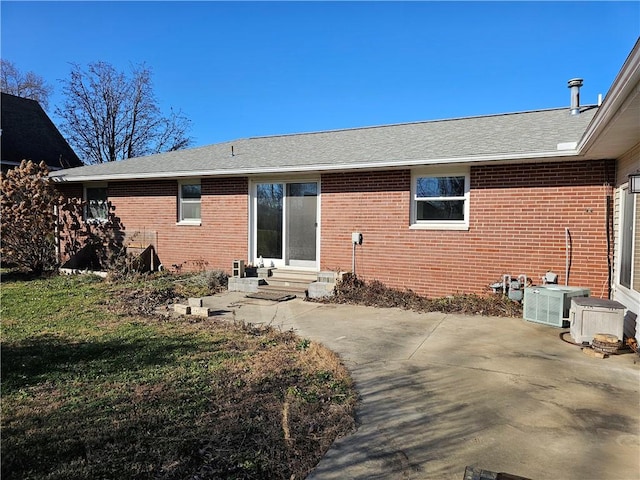 rear view of house featuring a yard and a patio