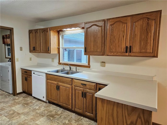 kitchen featuring sink, white dishwasher, and washer and dryer