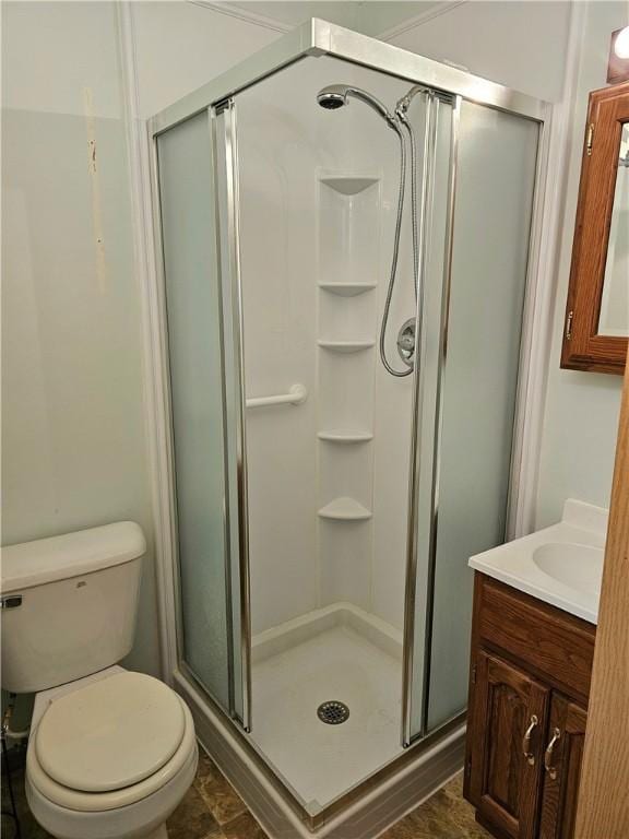 bathroom with toilet, an enclosed shower, and vanity