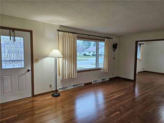 interior space with dark hardwood / wood-style flooring and a textured ceiling