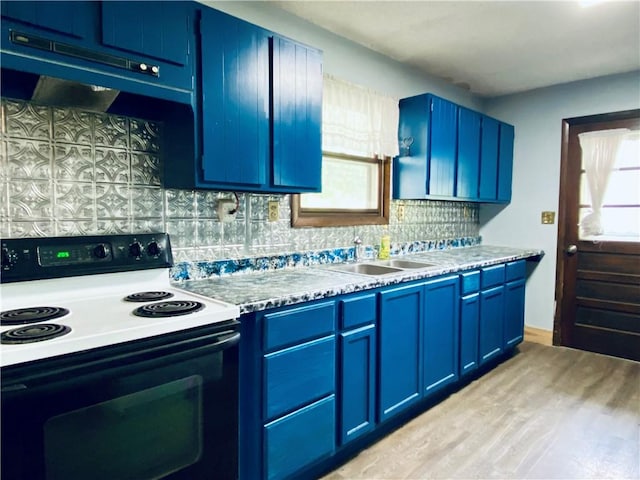 607 E Jefferson Ave, Casey, IL 62420 - kitchen with electric stove, blue cabinets, a sink, light wood-style flooring, and backsplash