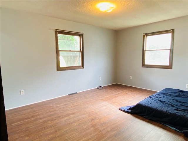 607 E Jefferson Ave, Casey, IL 62420 - bedroom featuring wood finished floors and baseboards