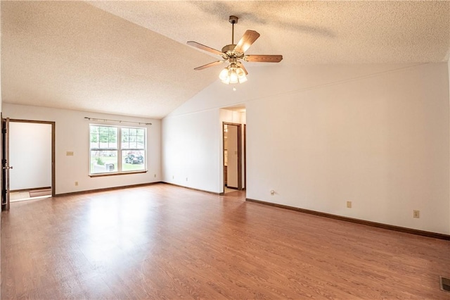 2008 Arthur Ave, Charleston, IL 61920 - empty room featuring a textured ceiling, wood finished floors, a ceiling fan, and vaulted ceiling