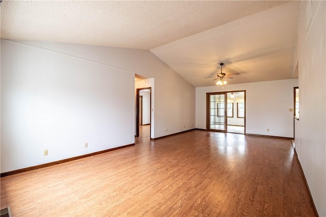 2008 Arthur Ave, Charleston, IL 61920 - spare room featuring wood finished floors, vaulted ceiling, a ceiling fan, and a textured ceiling
