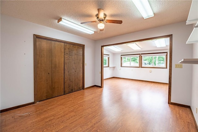 2008 Arthur Ave, Charleston, IL 61920 - unfurnished bedroom with light wood finished floors, a textured ceiling, a closet, and a ceiling fan