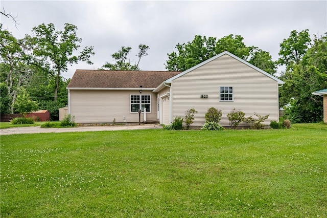 2008 Arthur Ave, Charleston, IL 61920 - back of house featuring a garage, a lawn, and driveway