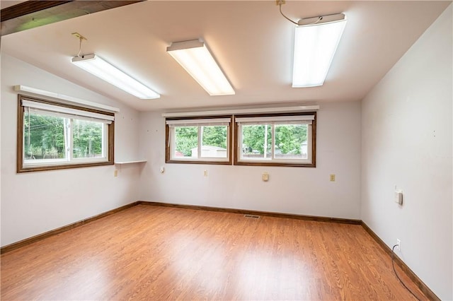 2008 Arthur Ave, Charleston, IL 61920 - unfurnished room with light wood-type flooring and vaulted ceiling