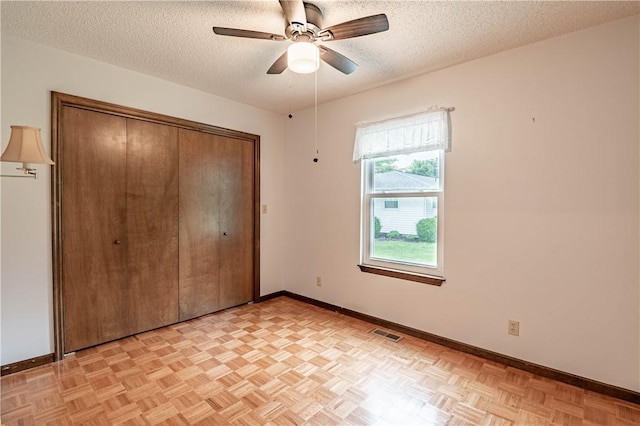 2008 Arthur Ave, Charleston, IL 61920 - unfurnished bedroom with a textured ceiling, a closet, and ceiling fan