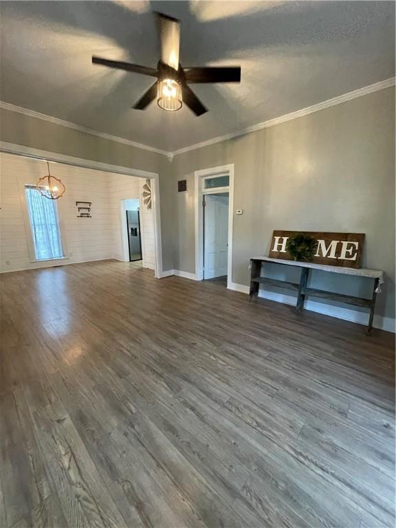 510 S 5th St, Marshall, IL 62441 - unfurnished living room featuring ceiling fan, wood finished floors, ornamental molding, and a chandelier