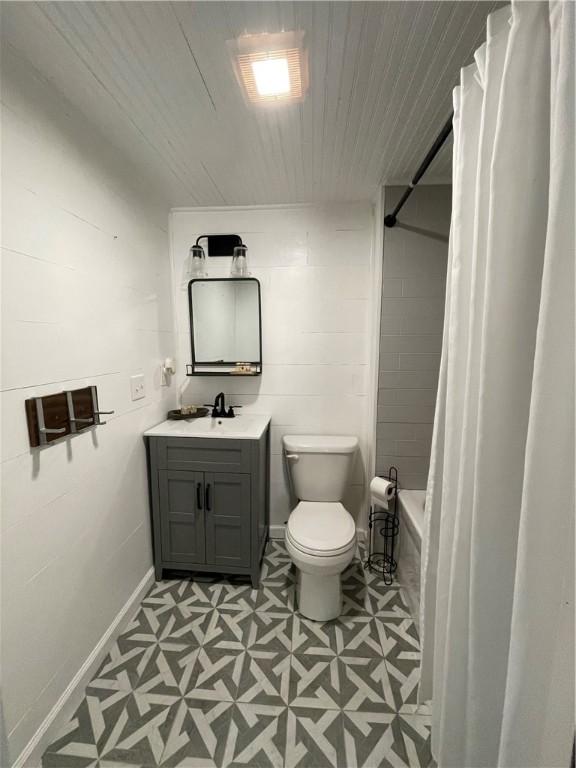510 S 5th St, Marshall, IL 62441 - bathroom with vanity, tile patterned floors, wood ceiling, and shower / tub combo