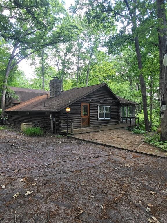 3848 Cahokia Ln, Charleston, IL 61920 - view of front facade with a chimney and log siding
