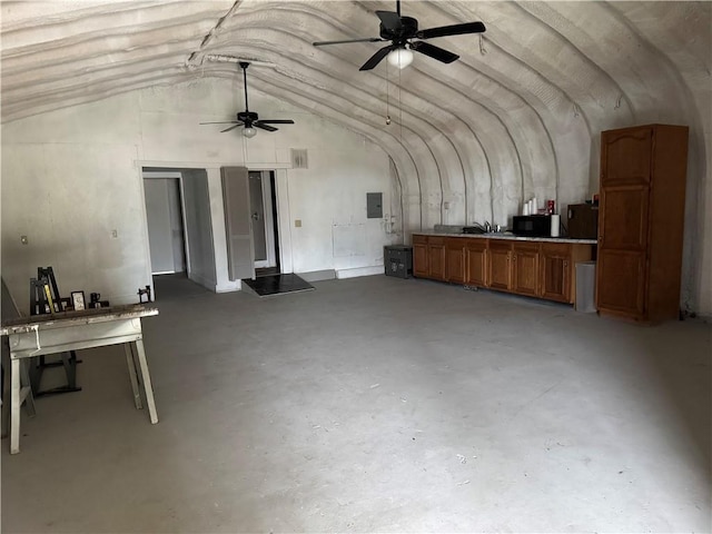 miscellaneous room featuring electric panel, ceiling fan, concrete floors, and vaulted ceiling