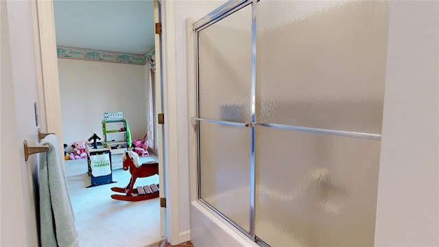 bathroom featuring bath / shower combo with glass door