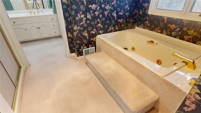 bathroom with vanity and a bathtub