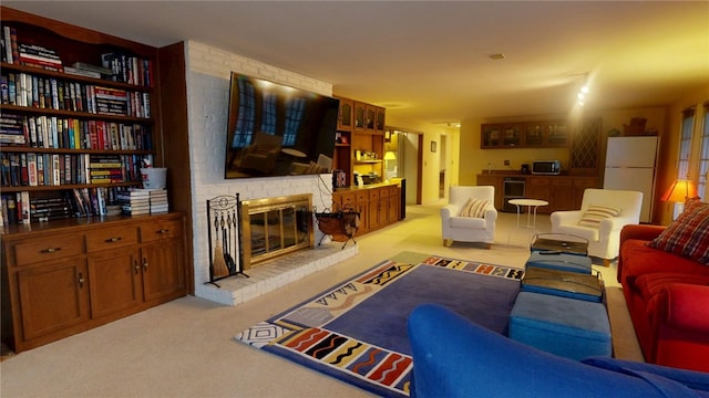 living room featuring wine cooler, light colored carpet, and a brick fireplace