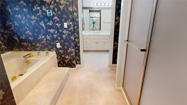 bathroom featuring a tub to relax in and vanity