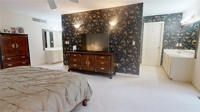 carpeted bedroom featuring connected bathroom and ceiling fan