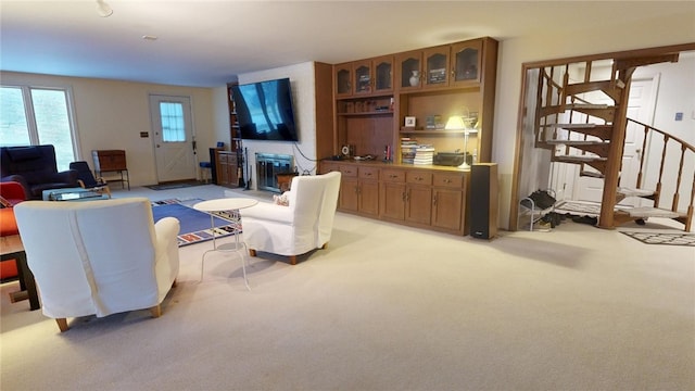 carpeted living room with a brick fireplace