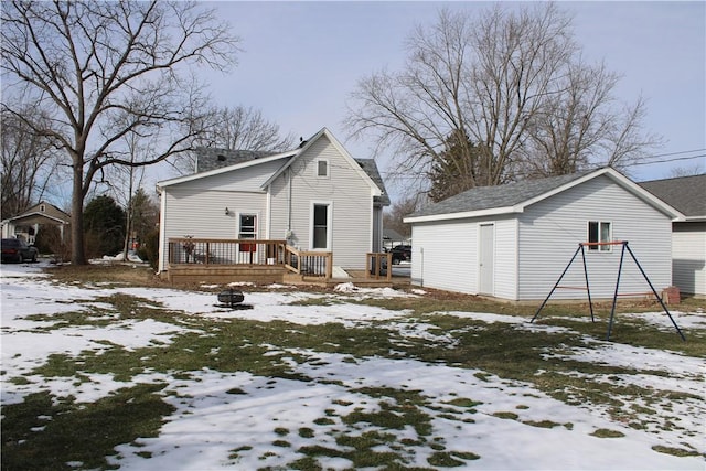 snow covered rear of property featuring a deck and a fire pit