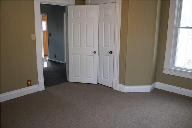 unfurnished bedroom featuring a closet and carpet