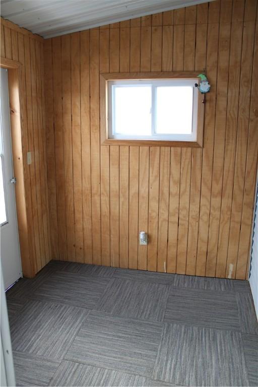 spare room featuring wooden walls