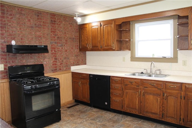 kitchen featuring extractor fan, sink, wood walls, and black appliances