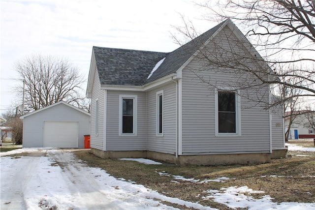 exterior space with a garage and an outdoor structure