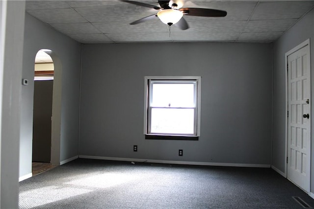 carpeted empty room featuring a paneled ceiling and ceiling fan