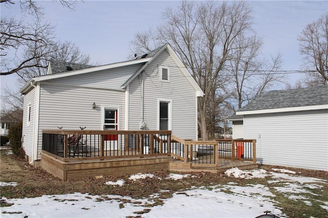 snow covered property featuring a deck