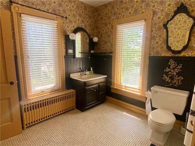 401 E Fourth St, Pana, IL 62557 - bathroom featuring radiator heating unit, wallpapered walls, a wainscoted wall, toilet, and vanity