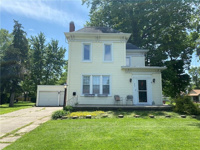 401 E Fourth St, Pana, IL 62557 - view of front of house featuring a chimney, a front yard, and concrete driveway