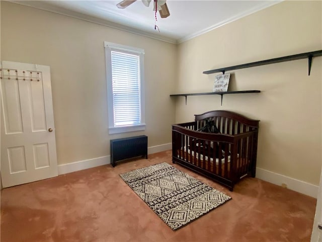 401 E Fourth St, Pana, IL 62557 - carpeted bedroom with crown molding, baseboards, a nursery area, and ceiling fan