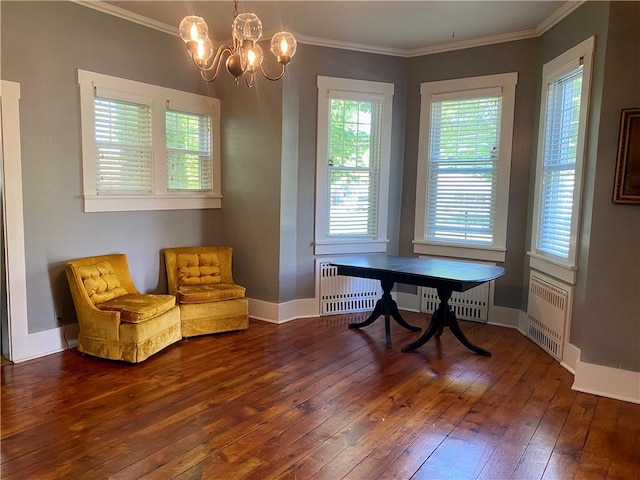 401 E Fourth St, Pana, IL 62557 - living area featuring radiator, hardwood / wood-style flooring, ornamental molding, a chandelier, and baseboards