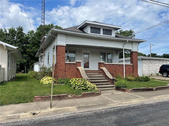105 S Lafayette St, Newton, IL 62448 - bungalow with brick siding, a front lawn, and covered porch