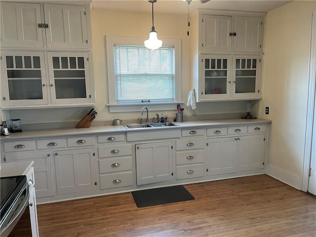 105 S Lafayette St, Newton, IL 62448 - kitchen with white cabinetry, light wood-style flooring, hanging light fixtures, and glass insert cabinets