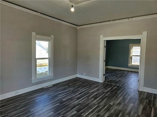 unfurnished room featuring a wealth of natural light, dark hardwood / wood-style flooring, and crown molding