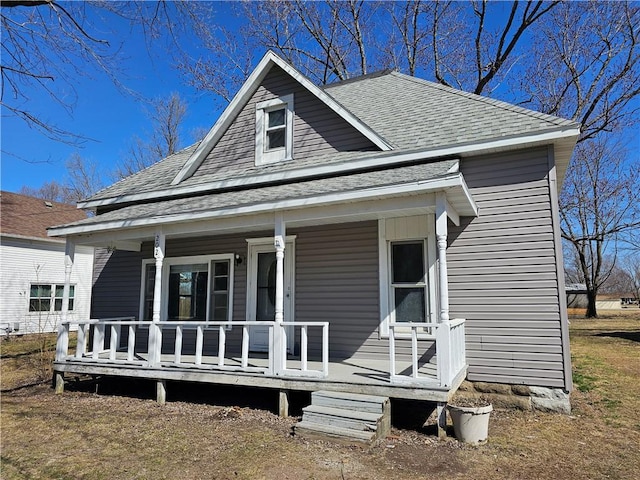 view of front facade featuring covered porch and roof with shingles