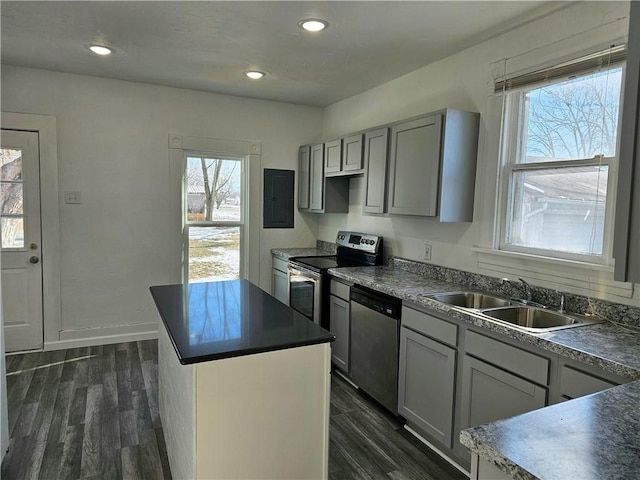 kitchen featuring a center island, gray cabinetry, dark hardwood / wood-style flooring, stainless steel appliances, and electric panel